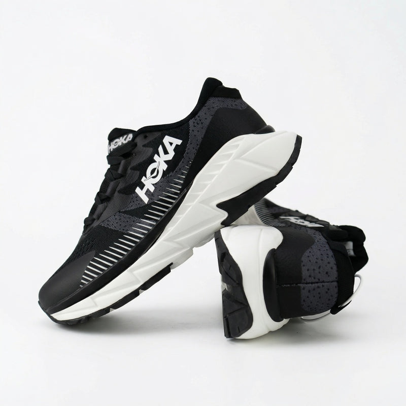 SOLES men's black running shoes with white cushioned sole, pair shown with one shoe tilted to show the sole unit